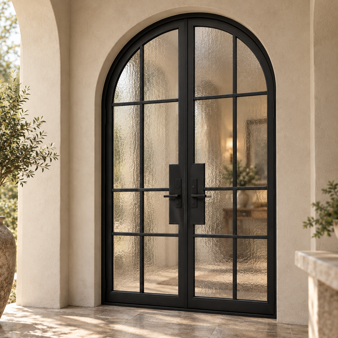 Arched black double French iron doors installed in a stone entrance