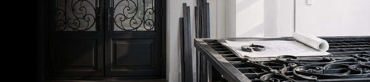 Iron door design sketches displayed in a workshop