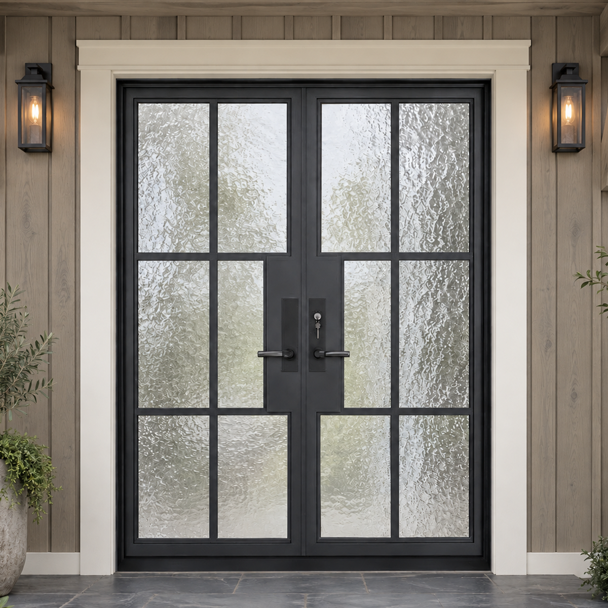 Black iron French entry doors installed at a residential exterior with divided textured glass