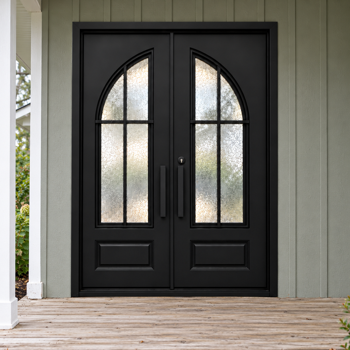 Black double modern iron doors with curved textured glass insets and a square top frame on a wood porch