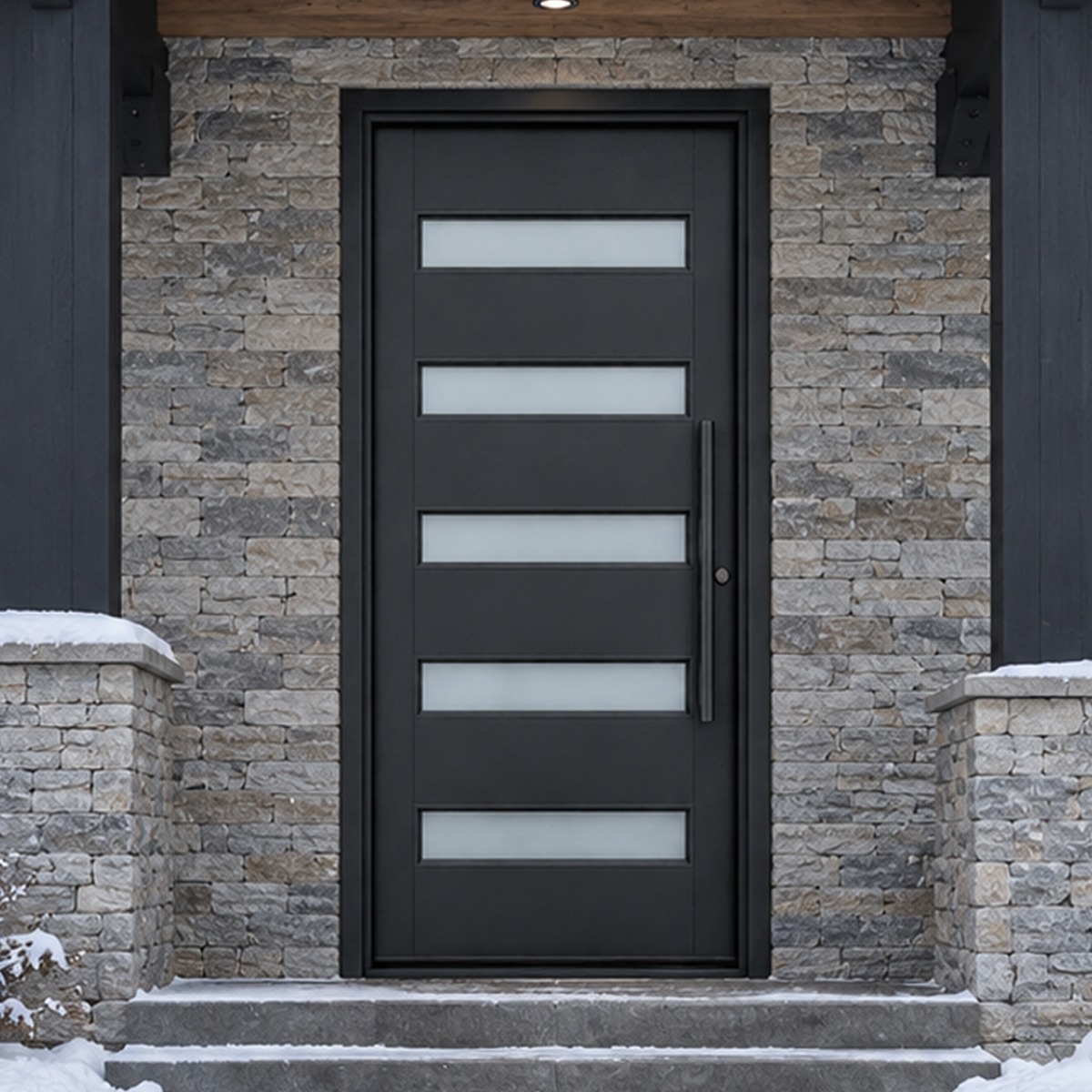 Modern black iron entry door installed in a cold-climate stone exterior entrance
