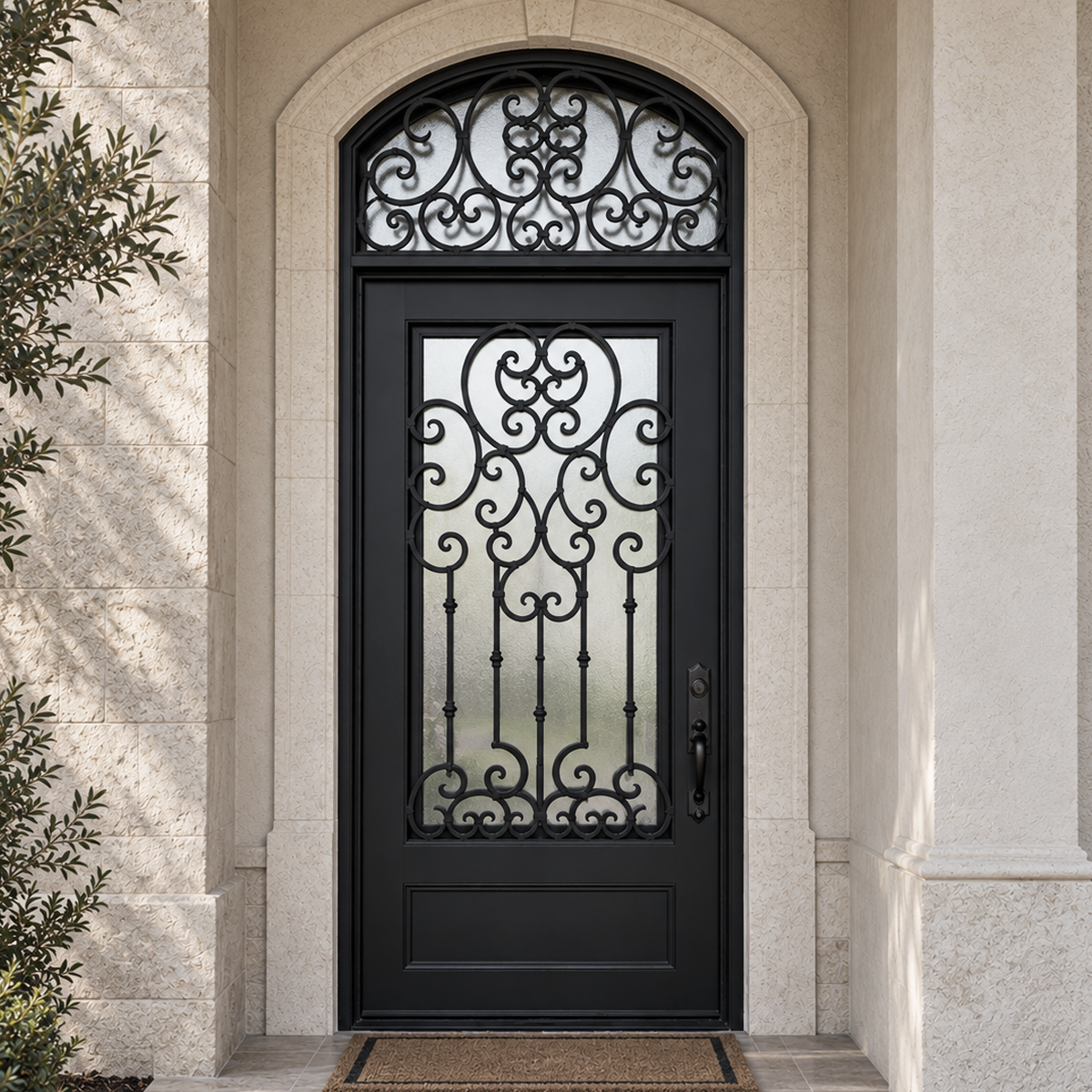 Traditional black iron entry door with decorative arched transom installed at an upscale American stone entrance