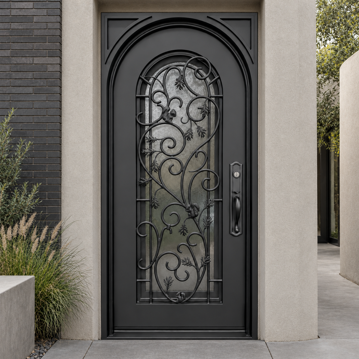 Black single traditional iron door with leaf and vine scrollwork and arched glass in a stucco and brick entrance