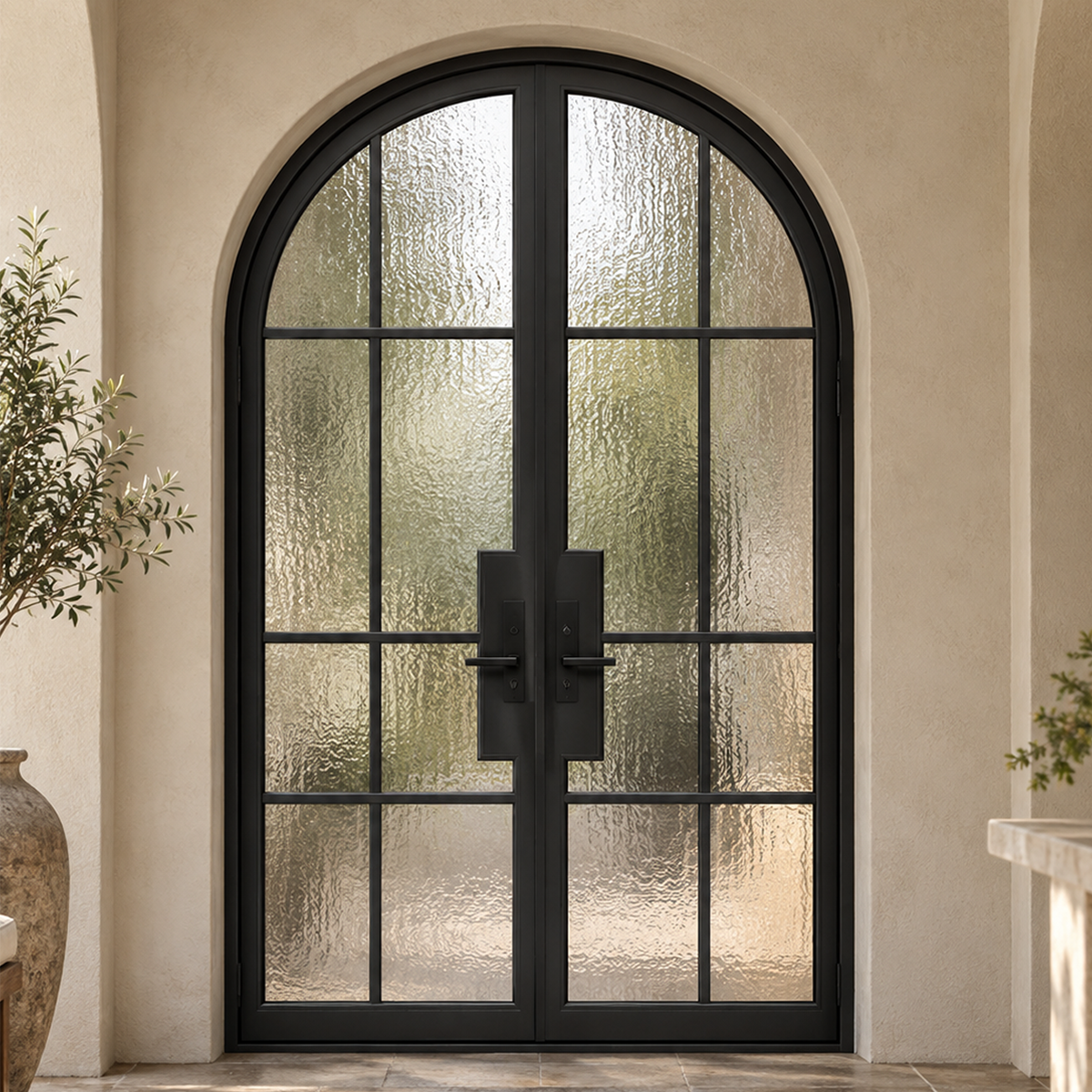 Traditional arched iron French entry doors with textured privacy glass in a stucco residential entrance