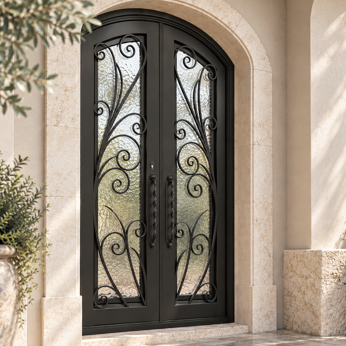 Traditional double iron entry door with decorative scrollwork, textured privacy glass and arched stone surround